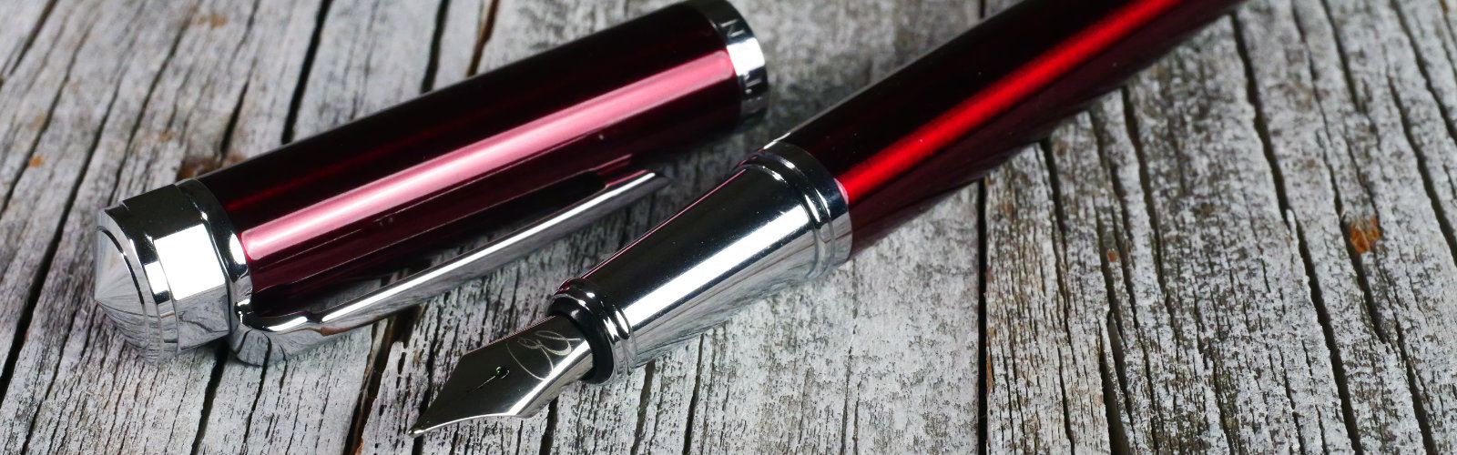 Fountain pens next to drawing